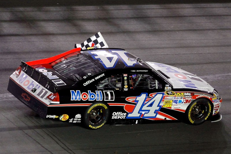 NASCAR, 2012 Coke Zero 400 Powered by Coca-Cola, Tony Stewart, winner of the race, carries flag.