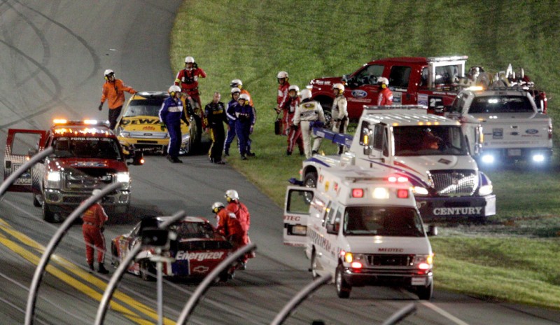 NASCAR, 2012 Coke Zero 400 Powered by Coca-Cola, Marcos Ambrose evacuating from his car.