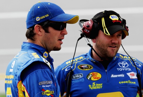 Martin Truex Jr., driver of the #56 NAPA Auto Parts Toyota, talks with crew chief Chad Johnston on the grid during qualifying at Talladega fall race 2012