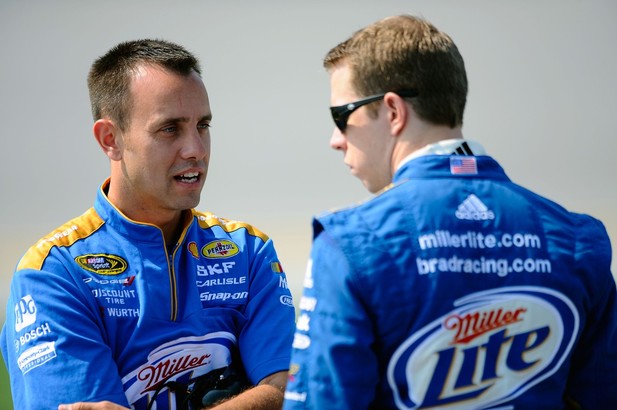 Brad Keselowski (R), driver of the #2 Miller Lite Dodge, talks with crew chief Paul Wolfe on the grid during qualifying at Talladega fall race 2012