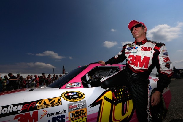 Greg Biffle, driver of the #16 3M/National Breast Cancer Foundation Ford, climbs out of his car after qualifying at Talladega fall race 2012