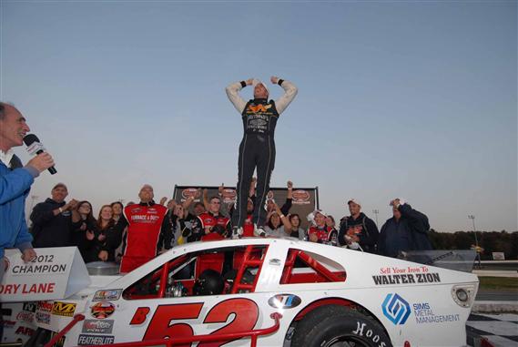 Doug Coby celebrates winning the 2012 NASCAR Whelen Modified Tour championship, which he clinched by finishing 6th in Sunday's 