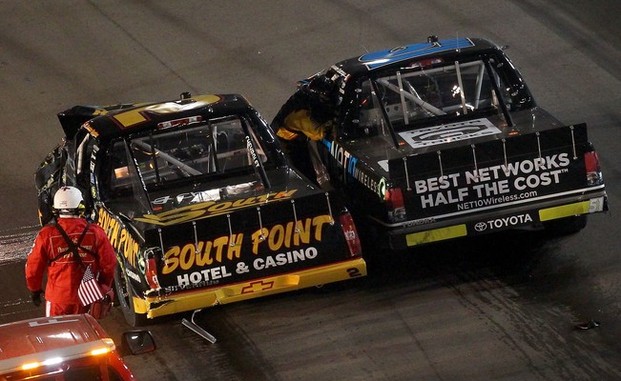 AVONDALE, AZ - NOVEMBER 09: Brendan Gaughan, driver of the #2 South Point Hotel & Casino Chevrolet, talks with German Quiroga, driver of the #51 NET10 Wireless Toyota, after an on-track incident during the NASCAR Camping World Truck Series Lucas 