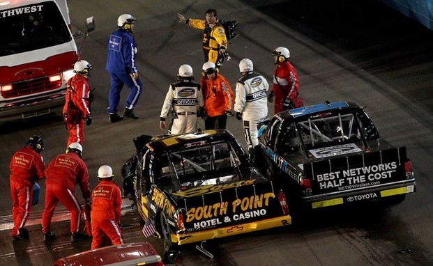 AVONDALE, AZ - NOVEMBER 09: Brendan Gaughan, driver of the #2 South Point Hotel & Casino Chevrolet, talks with German Quiroga, driver of the #51 NET10 Wireless Toyota, after an on-track incident during the NASCAR Camping World Truck Series Lucas 