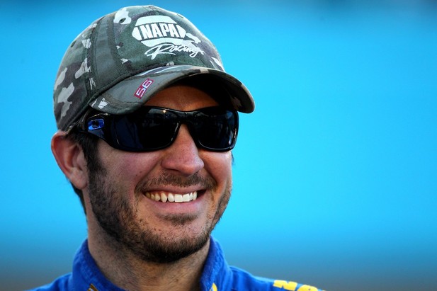 AVONDALE, AZ - NOVEMBER 09: Martin Truex Jr., driver of the #56 NAPA Auto Parts Toyota, smiles on the grid during qualifying for the NASCAR Sprint Cup Series AdvoCare 500 at Phoenix International Raceway on November 9, 2012 in Avondale, Arizona. 