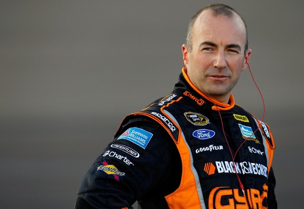 AVONDALE, AZ - NOVEMBER 09: Marcos Ambrose, driver of the #9 Black & Decker Ford, stands on the grid during qualifying for the NASCAR Sprint Cup Series AdvoCare 500 at Phoenix International Raceway on November 9, 2012 in Avondale, Arizona.