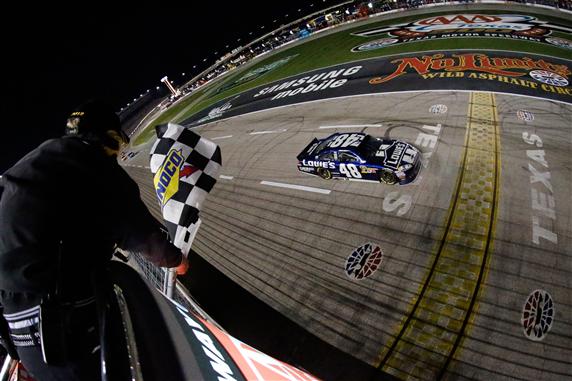 Jimmie Johnson crosses the finish line to win the NASCAR Sprint Cup Series 