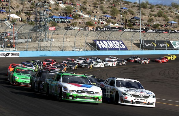 Joey Logano, driver of the #18 GameStop/Epic Mickey2 Toyota, and Ricky Stenhouse Jr., driver of the #6 Valvoline NextGen Ford, lead the field to a restart in the NASCAR Nationwide Series Great Clips 200 at Phoenix