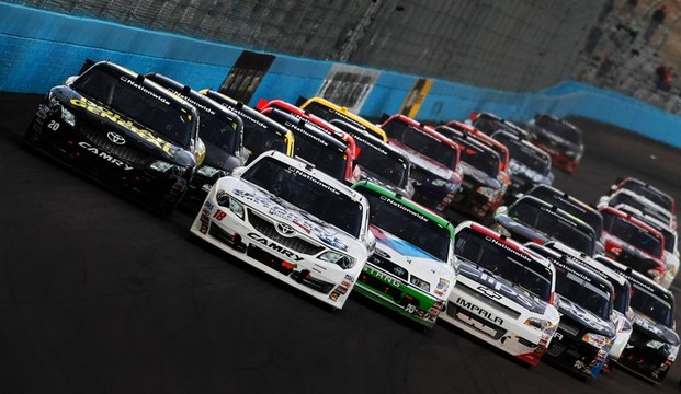 Joey Logano, driver of the #18 GameStop/Epic Mickey2 Toyota and Brian Vickers, driver of the #20 Dollar General Toyota, lead the field on the final restart during the NASCAR Nationwide Series Great Clips 200 at Phoenix