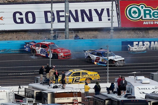 Elliott Sadler, driver of the #2 OneMain Financial Chevrolet, and Cole Whitt, driver of the #88 Takagi Chevrolet, spin after being involved in an on track incident during the NASCAR Nationwide Series Great Clips 200 at Phoenix