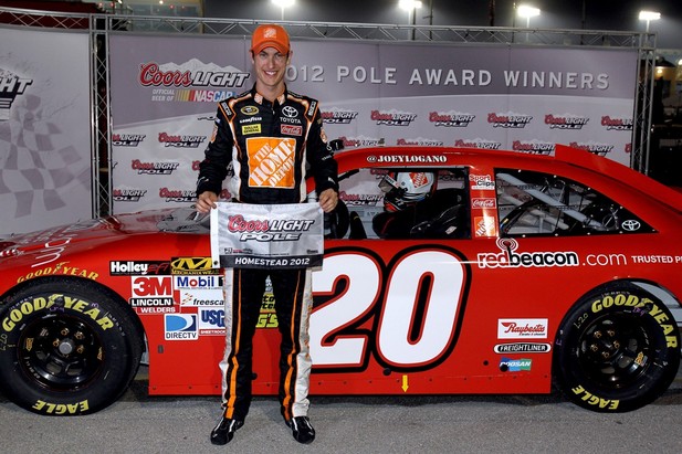 Joey Logano, driver of the #20 Home Depot/redbeacon.com Toyota, poses after qualifying for the pole position in the NASCAR Sprint Cup Series Ford EcoBoost 400 at Homestead