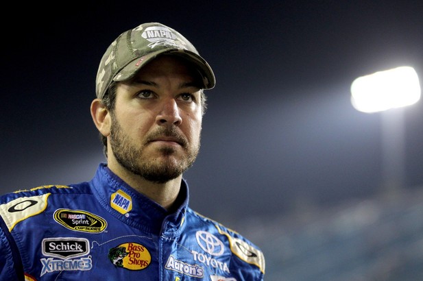 Martin Truex Jr., driver of the #56 NAPA Auto Parts Toyota, stands on the grid during qualifying for the NASCAR Sprint Cup Series Ford EcoBoost 400 at Homestead