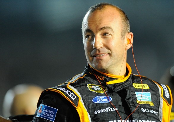 Marcos Ambrose, driver of the #9 Black & Decker Ford, stands on the grid during qualifying for the NASCAR Sprint Cup Series Ford EcoBoost 400 at Homestead
