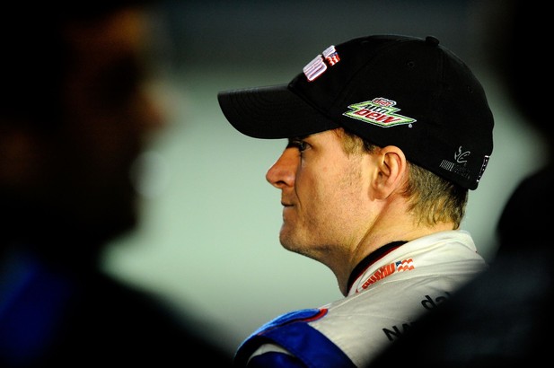 Dale Earnhardt Jr., driver of the #88 National Guard/Diet Mountain Dew Chevrolet, stands on the grid during qualifying for the NASCAR Sprint Cup Series Ford EcoBoost 400 at Homestead