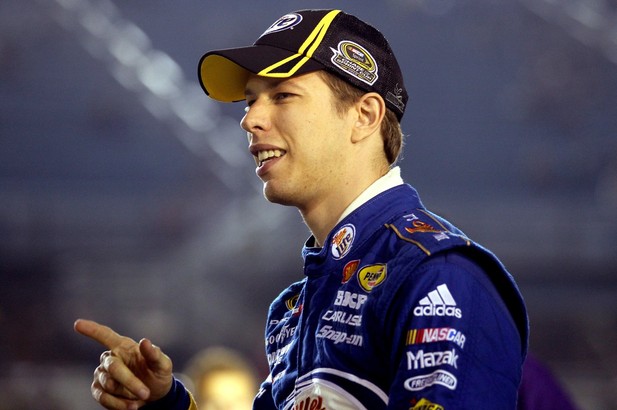 Brad Keselowski, driver of the #2 Miller Lite Dodge, points on the grid during qualifying for the NASCAR Sprint Cup Series Ford EcoBoost 400 at Homestead
