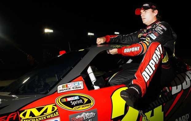 Jeff Gordon, driver of the #24 DuPont 20 Years Celebratory Chevrolet, climbs out of his car after qualifying for the NASCAR Sprint Cup Series Ford EcoBoost 400 at Homestead