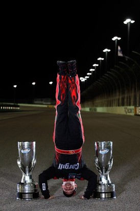 Ricky Stenhouse Jr., driver of the #6 Cargill Ford, does a handstand on the track after winning back-to-back Nationwide series championships after competing in the NASCAR Nationwide Series Ford EcoBoost 300 at Homestead