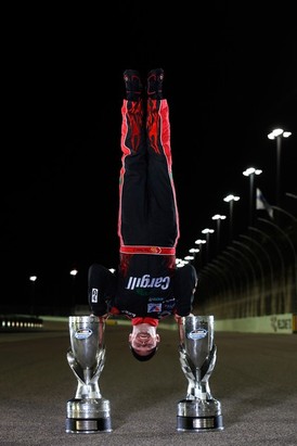 Ricky Stenhouse Jr., driver of the #6 Cargill Ford, does a handstand on the track after winning back-to-back Nationwide series championships after competing in the NASCAR Nationwide Series Ford EcoBoost 300 at Homestead