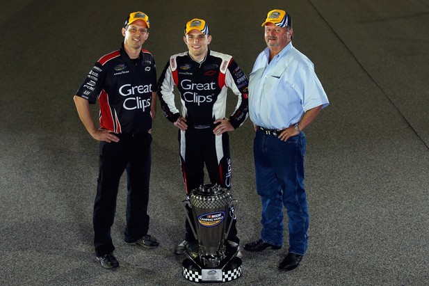 Crew Chief Michael Shelton, James Buescher, driver of the #31 Great Clips Chevrolet, and Team Owner Steve Turner pose for a photo after winning the NASCAR Camping World Truck Series Championship after the Ford EcoBoost 200 at Homestead