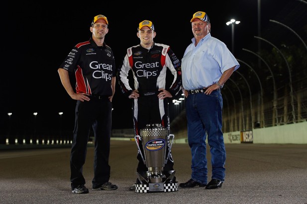 Crew Chief Michael Shelton, James Buescher, driver of the #31 Great Clips Chevrolet, and Team Owner Steve Turner pose for a photo after winning the NASCAR Camping World Truck Series Championship after the Ford EcoBoost 200 at Homestead