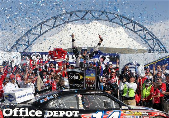 2012 Season in Review: Defending Sprint Cup champion Tony Stewart celebrates his first win with crew chief Steve Addington after his victory in the 