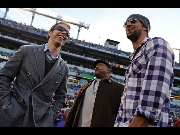 Brad Keselowski (L), the 2012 Sprint Cup champion, laughs with olympian Michael Phelps (R) before the the New York Giants play the Baltimore Ravens at M&T Bank Stadium on December 23, 2012