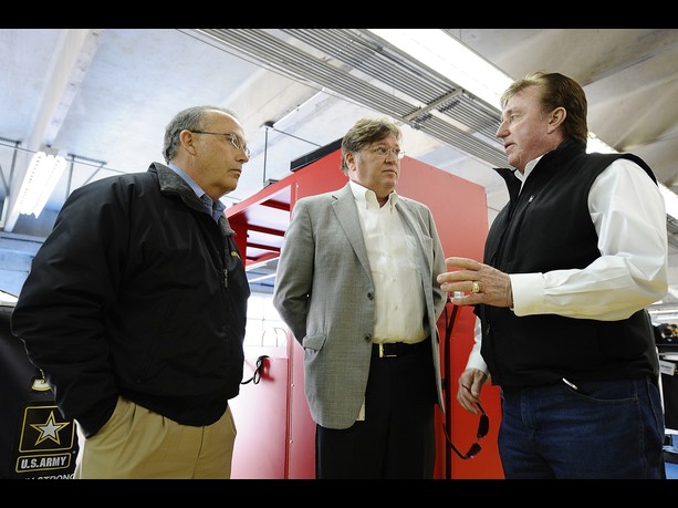 Brett Bodine, NASCAR Sprint Cup Series pace car driver, Robin Pemberton, vice president of competition for NASCAR, and Richard Childress, owner of Richard Childress Racing, speak in the garage area during testing at Charlotte Motor Speedway on Decem