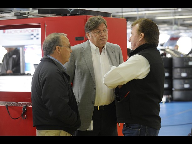 Brett Bodine, NASCAR Sprint Cup Series pace car driver, Robin Pemberton, vice president of competition for NASCAR, and Richard Childress, owner of Richard Childress Racing, speak in the garage area during testing at Charlotte on December 11, 2012