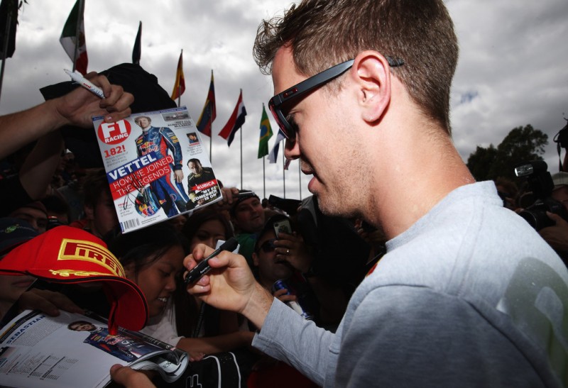Sebastian Vettel of Germany and Infiniti Red Bull Racing signs autographs for fans during previews to the Australian Formula One Grand Prix at the Albert Park Circuit on March 14, 2013 in Melbourne, Australia.