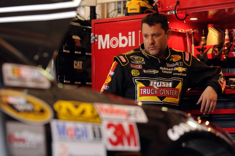 Tony Stewart, driver of the #14 Rush Truck Centers/Mobil 1 Chevrolet, stands in the garage area during practice for the NASCAR Sprint Cup Series Auto Club 400 at Auto Club Speedway on March 22, 2013 in Fontana, California. 