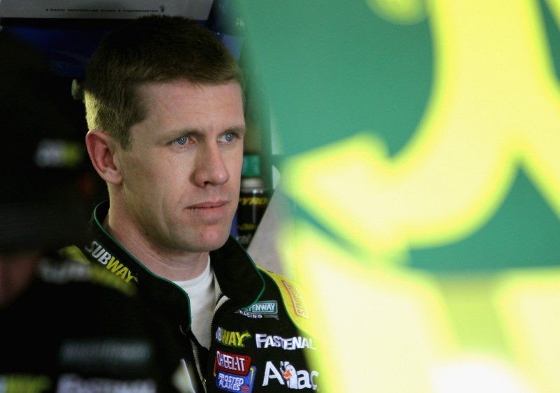 Carl Edwards, driver of the #99 Subway Ford, stands in the garage area during practice for the NASCAR Sprint Cup Series Auto Club 400 at Auto Club Speedway on March 22, 2013 in Fontana, California.