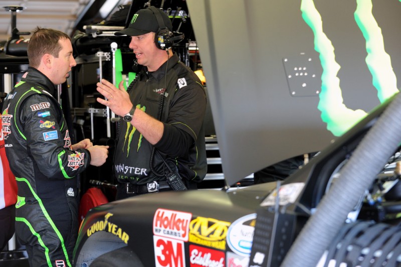 Kyle Busch, driver of the #54 Monster Energy Toyota, talks with a crew member during practice for the NASCAR Nationwide Series Royal Purple 300 at Auto Club Speedway on March 22, 2013 in Fontana, California. 