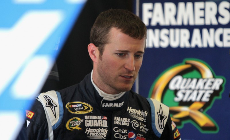 Kasey Kahne, driver of the #5 Farmers Insurance Chevrolet, stands over his car during practice for the NASCAR Sprint Cup Series Auto Club 400 at Auto Club Speedway on March 22, 2013 in Fontana, California.