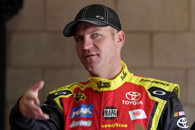 Clint Bowyer, driver of the #15 5-hour ENERGY Toyota, stands in the garage during practice for the NASCAR Sprint Cup Series Auto Club 400 at Auto Club Speedway on March 22, 2013 in Fontana, California.