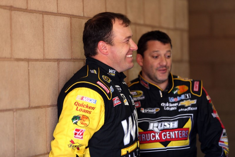 Ryan Newman (L), driver of the #39 WIX Filters Chevrolet, talks with Tony Stewart (R), driver of the #14 Rush Truck Centers/Mobil 1 Chevrolet, during practice for the NASCAR Sprint Cup Series Auto Club 400 at Auto Club Speedway on March 22, 2013 in F