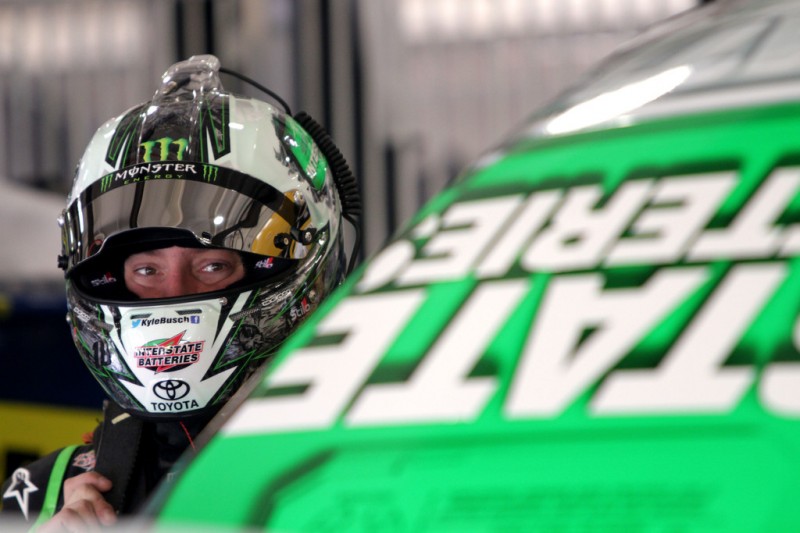 Kyle Busch, driver of the #18 Interstate Batteries Toyota, stands in the garage area during practice for the NASCAR Sprint Cup Series Auto Club 400 at Auto Club Speedway on March 22, 2013 in Fontana, California. 
