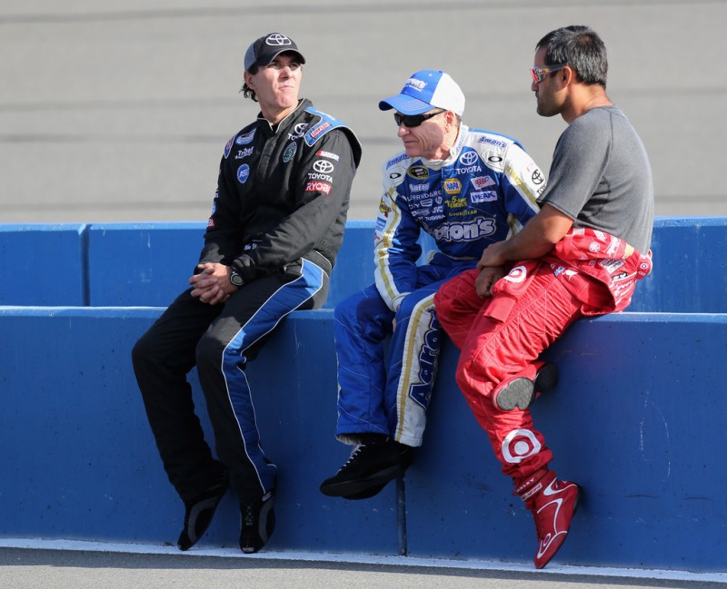 (L-R) Mike Bliss, driver of the #19 DoubleTree by Hilton Toyota, Mark Martin, driver of the #55 Aaron's Dream Machine Toyota, and Juan Pablo Montoya, driver of the #42 Target Chevrolet, talk on the grid during qualifying for the NASCAR Sprint Cu
