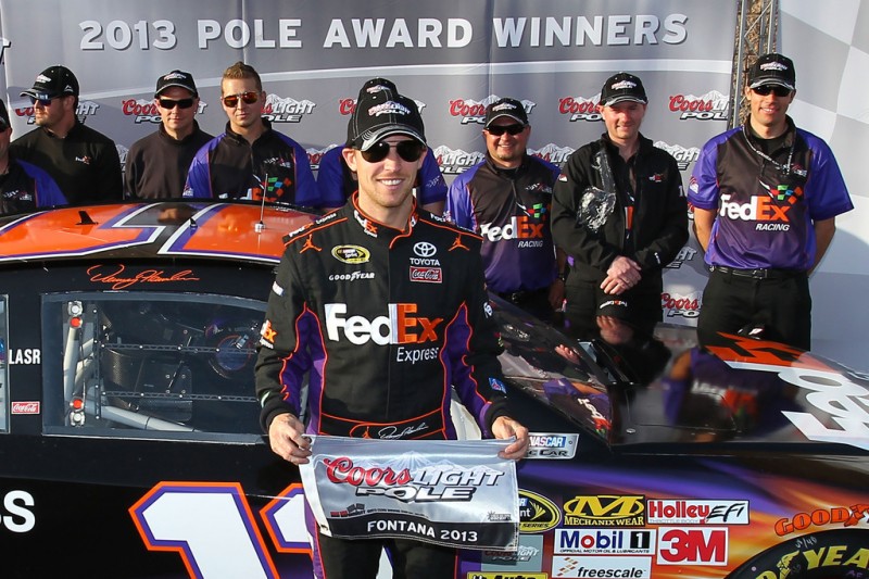 Denny Hamlin, driver of the #11 FedEx Express Toyota, poses after qualifying for the pole position in the NASCAR Sprint Cup Series Auto Club 400 at Auto Club Speedway on March 22, 2013 in Fontana, California. 