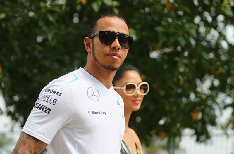 Lewis Hamilton of Great Britain and Mercedes GP and his girlfriend Nicole Scherzinger of the Pussycat Dolls arrive in the paddock before the Malaysian Formula One Grand Prix at the Sepang Circuit on March 24, 2013 in Kuala Lumpur, Malaysia. 