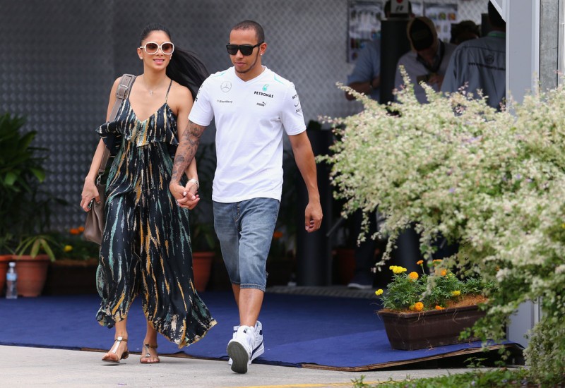 Lewis Hamilton of Great Britain and Mercedes GP and his girlfriend Nicole Scherzinger of the Pussycat Dolls arrive in the paddock before the Malaysian Formula One Grand Prix at the Sepang Circuit on March 24, 2013 in Kuala Lumpur, Malaysia. 