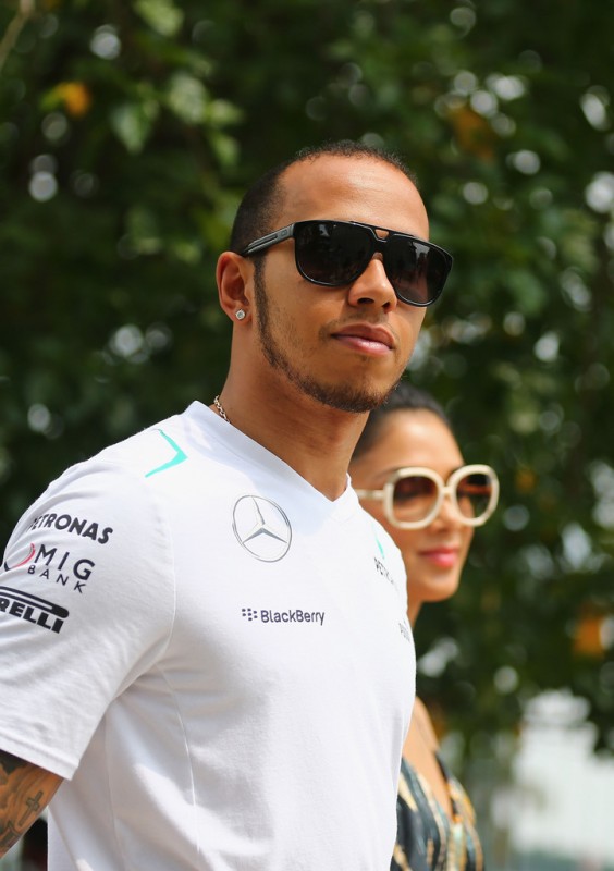 Lewis Hamilton of Great Britain and Mercedes GP and his girlfriend Nicole Scherzinger of the Pussycat Dolls arrive in the paddock before the Malaysian Formula One Grand Prix at the Sepang Circuit on March 24, 2013 in Kuala Lumpur, Malaysia. 