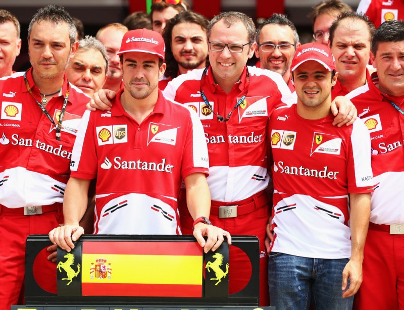 Fernando Alonso (L) of Spain celebrates with Ferrari Team Principal Stefano Domenicali (C), co-driver Felipe Massa (R) of Brazil and the rest of his team mates as he prepares to compete in his 200th Grand Prix race during the Malaysian Formula One Gr