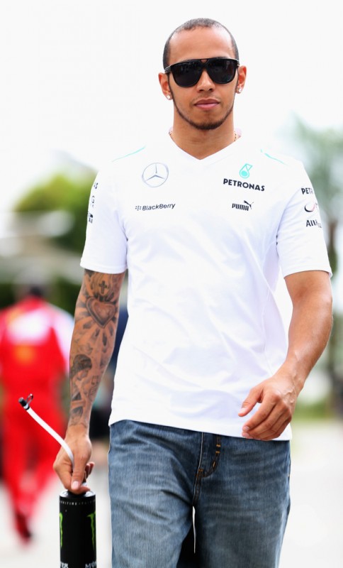 Lewis Hamilton of Great Britain and Mercedes GP arrives in the paddock before the Malaysian Formula One Grand Prix at the Sepang Circuit on March 24, 2013 in Kuala Lumpur, Malaysia. 
