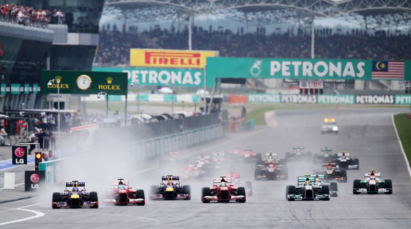 Sebastian Vettel (L) of Germany and Infiniti Red Bull Racing leads the field into turn one at the start of the Malaysian Formula One Grand Prix at the Sepang Circuit on March 24, 2013 in Kuala Lumpur, Malaysia. 