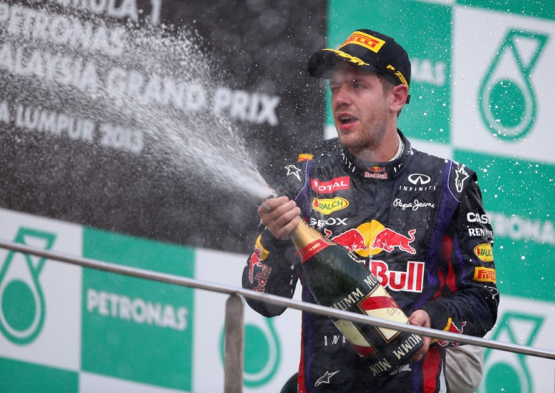 Sebastian Vettel of Germany and Infiniti Red Bull Racing celebrates on the podium after winning the Malaysian Formula One Grand Prix at the Sepang Circuit on March 24, 2013 in Kuala Lumpur, Malaysia. 