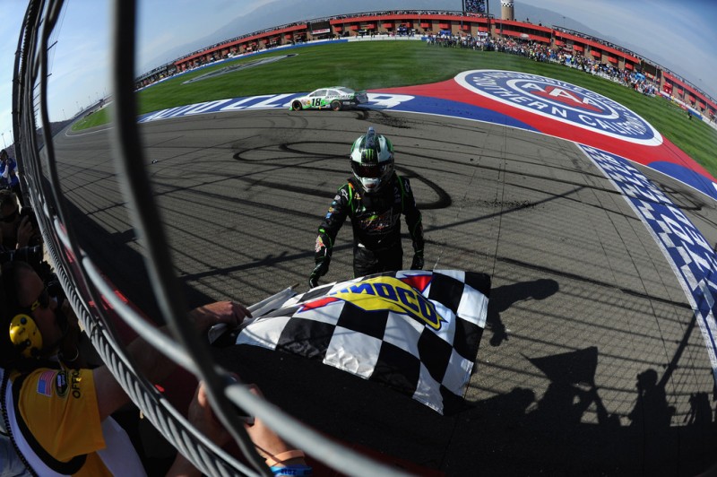 Kyle Busch, driver of the #18 Interstate Batteries Toyota, celebrates with the checkered flag after winning the NASCAR Sprint Cup Series Auto Club 400 at Auto Club Speedway on March 24, 2013 in Fontana, California. 