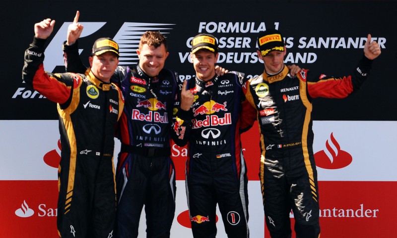 Race winner Sebastian Vettel (2nd right) of Germany and Infiniti Red Bull Racing celebrates on the podium with second placed Kimi Raikkonen (left) of Finland and Lotus, third placed Romain Grosjean (right) of France and Lotus and his number one mecha