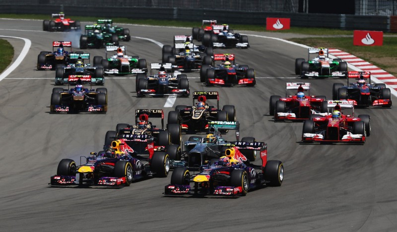 Sebastian Vettel (L) of Germany and Infiniti Red Bull Racing and Mark Webber (R) of Australia and Infiniti Red Bull Racing lead the field into the first corner at the start of the German Grand Prix at the Nuerburgring on July 7, 2013 in Nuerburg, Ger