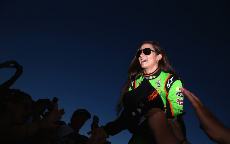 Danica Patrick, driver of the #10 GoDaddy.com Chevrolet, greets fans during driver introductions during the NASCAR Sprint Cup Series Coke Zero 400 at Daytona International Speedway on July 6, 2013 in Daytona Beach, Florida.