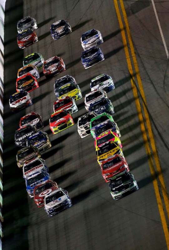 (Lead cars L-R) Jamie McMurray, driver of the #1 Cessna Chevrolet and Denny Hamlin, driver of the #11 FedEx Ground Toyota, lead the field during the NASCAR Sprint Cup Series Coke Zero 400 at Daytona International Speedway on July 6, 2013 in Daytona B